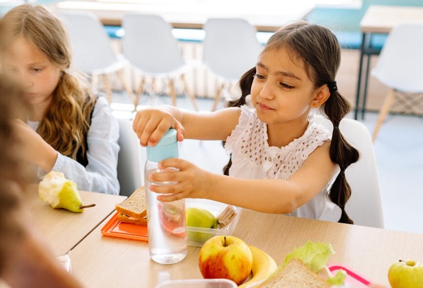 girl in white sleeveless shirt glass tumbler